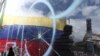 La bandera venezolana es vista a través de un cristal roto durante una manifestación contra Nicolás Maduro en Caracas. (Archivo)