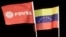 BAR01- BARCELONA (VENEZUELA), 01/05/07.- Un trabajador de Petróleos de Venezuela S.A (PDVSA) sonríe durante un acto celebrado hoy, 1 de mayo de 2007, en Barcelona(Venezuela). El ministro venezolano de Energía y Petróleo, Rafael Ramírez, anunció que el Est